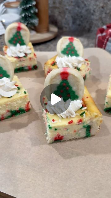 several pieces of cake sitting on top of a table with icing and christmas decorations