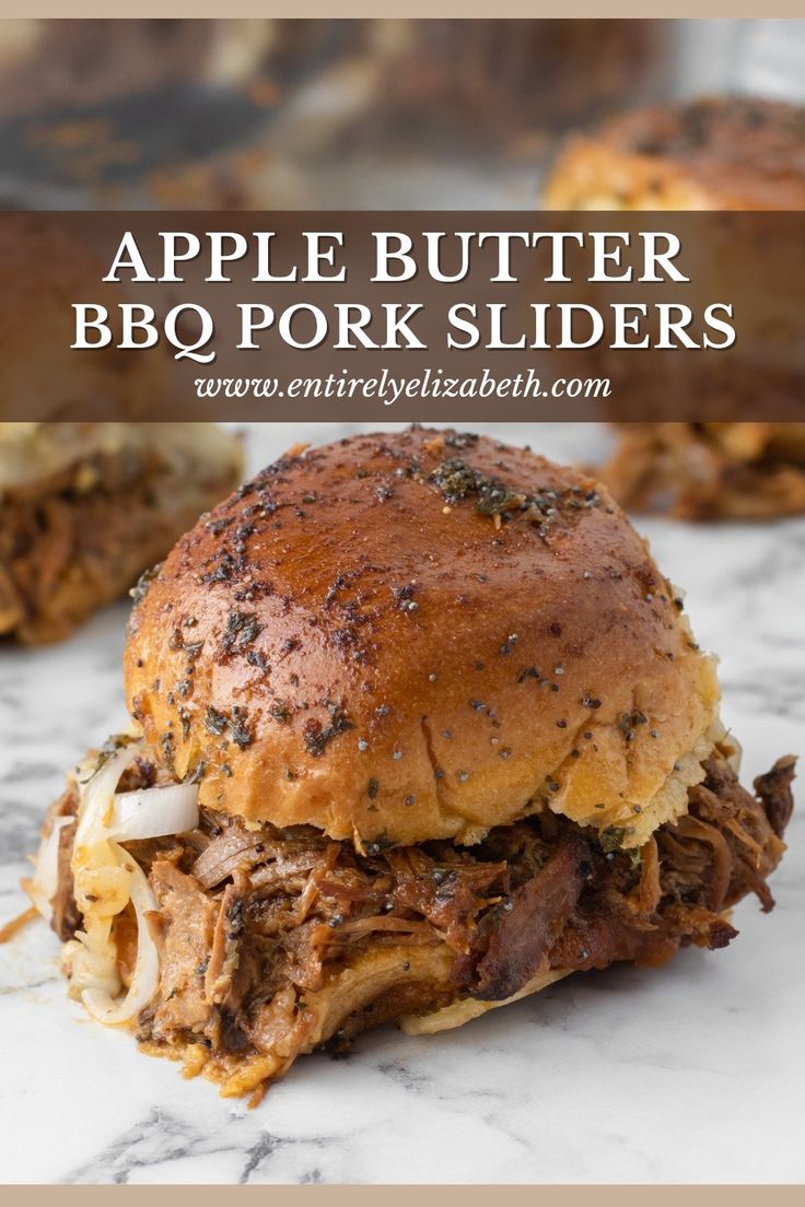 a close up of a pulled pork slider on a marble surface with text overlay