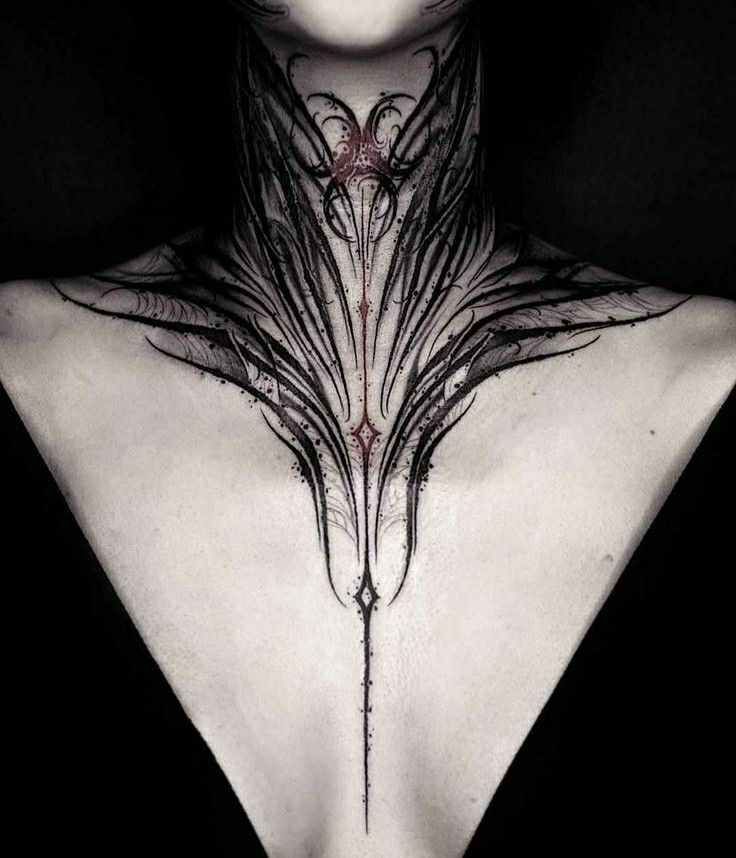 the back of a woman's neck with tattoos on her chest and hands behind her