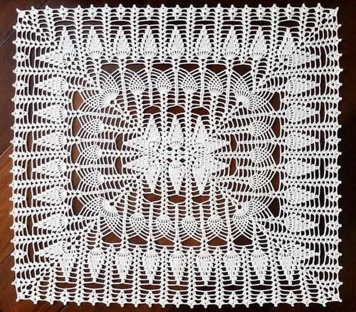 a white crocheted doily on a wooden table