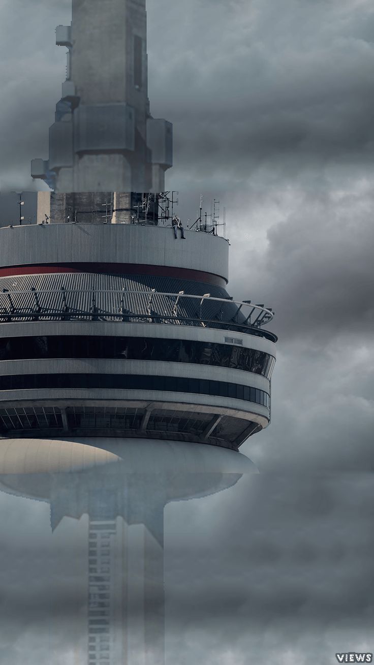 an airplane is flying over the top of a tall building with a clock on it's side