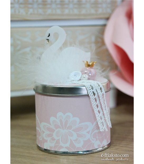 there is a pink tin with a white swan on it and a flower in the top