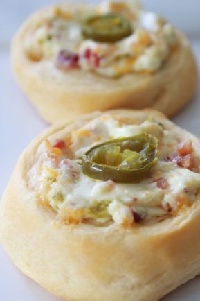 two mini pizzas with cheese and peppers on top