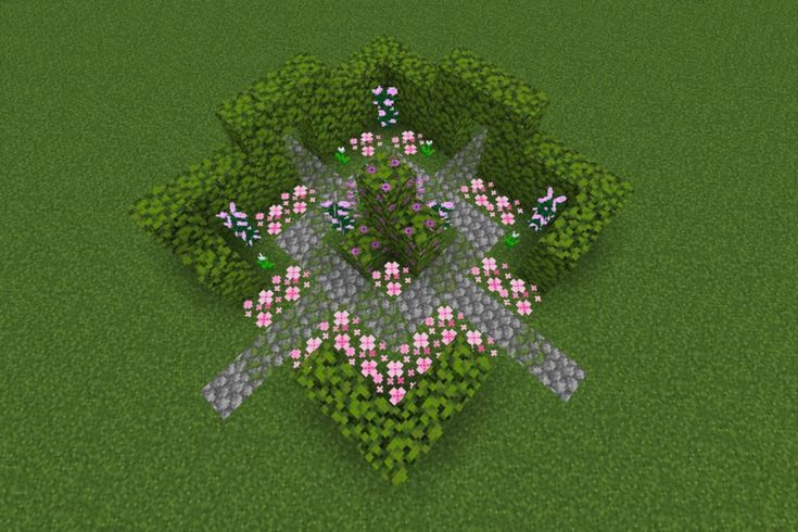 an aerial view of a tree with pink flowers in the center and two birds flying over it