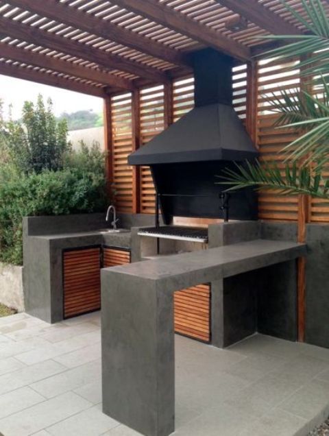 an outdoor kitchen is shown with grill and counter space for the cooking area to sit on