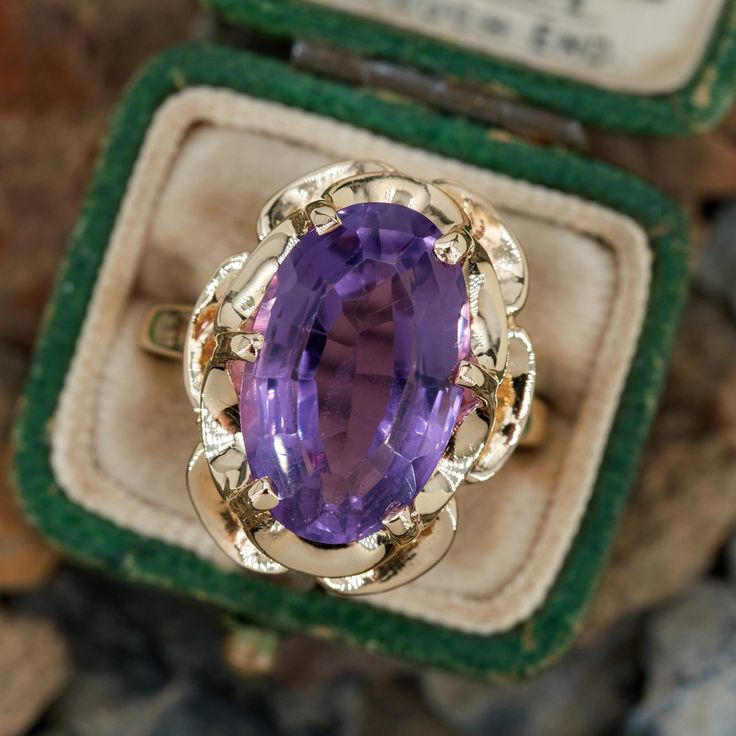 This vintage buttercup style ring features an oval step cut amethyst in a six prong setting. It is crafted in 14k yellow gold and currently a size 7.5. Heirloom Style Purple Oval Amethyst Ring, Heirloom Yellow Gold Oval Amethyst Ring, Oval Amethyst Ring With Center Stone In Heirloom Style, Heirloom Style Oval Amethyst Ring Stamped 14k, Heirloom Oval Amethyst Ring With Center Stone, Oval Amethyst Heirloom Ring With Prong Setting, Yellow Gold Oval Amethyst Ring With Prong Setting, Oval Amethyst Ring In Yellow Gold With Prong Setting, Vintage Oval Cabochon Amethyst Ring For Anniversary