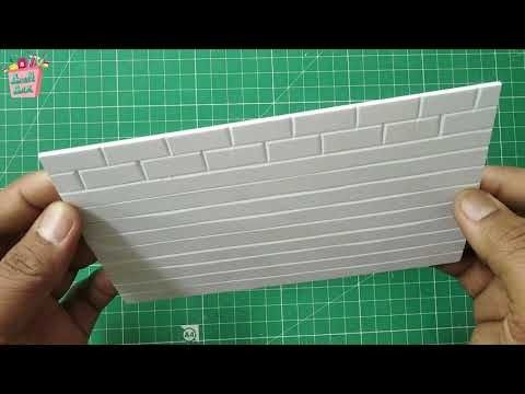 someone is making a white brick wall out of plastic bricks on a green cutting board