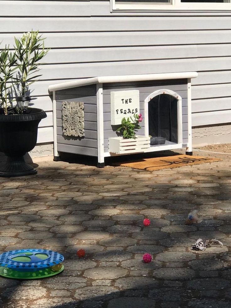 a dog house that is outside on the ground