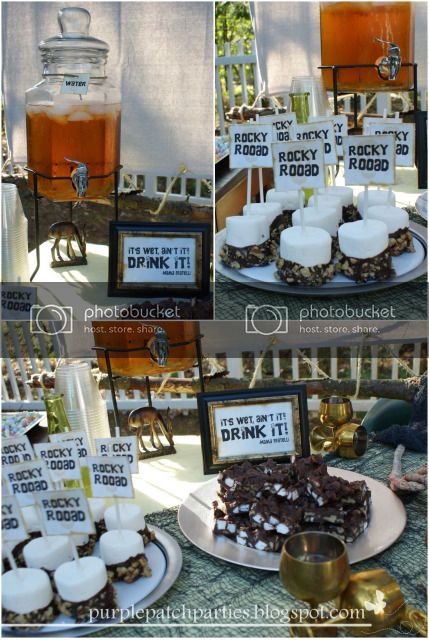 the dessert table is decorated with candles and signs