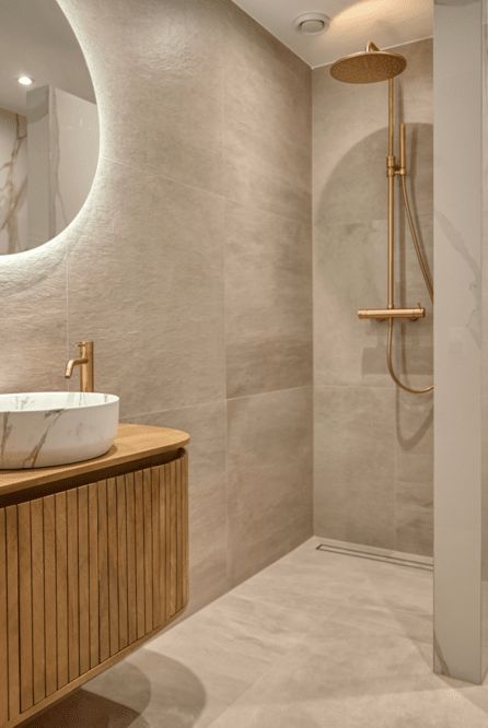 a bathroom with a sink, mirror and shower stall in it's corner area