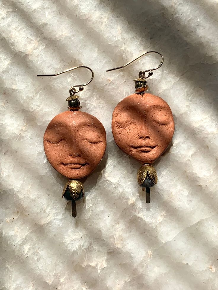 a pair of earrings that have been made out of copper