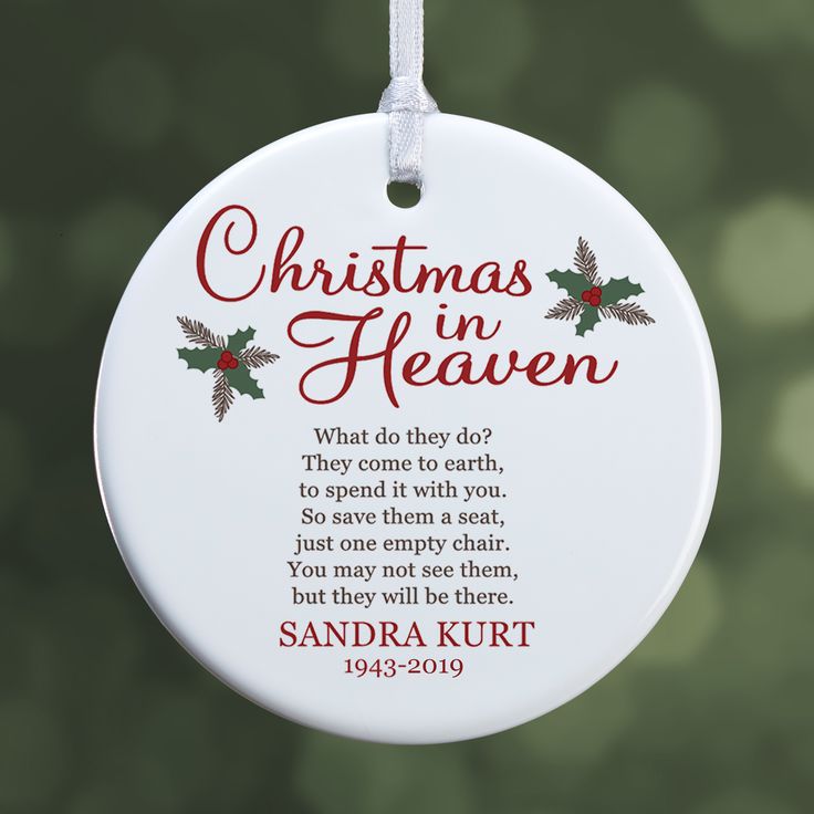 a christmas ornament hanging from a tree with the words, christmas in heaven