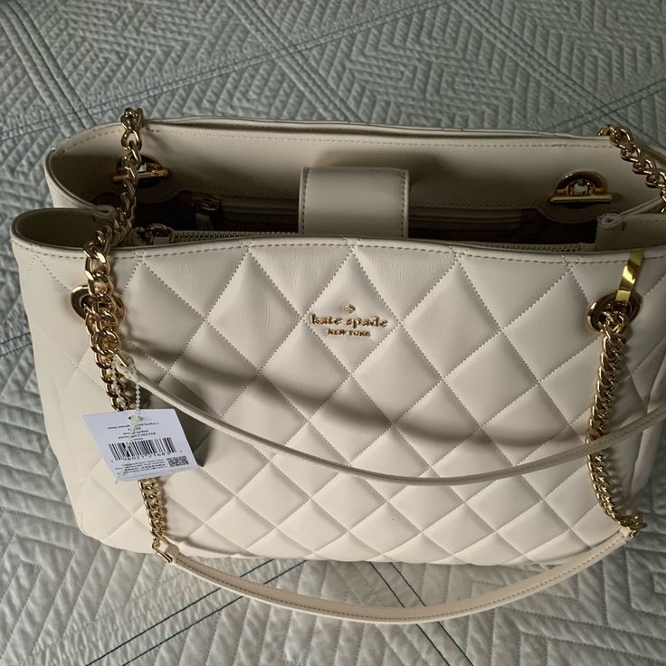 Kate Spade Carey Smooth Quilted Leather Handbag Elegant Satchel With Dust Bag For Errands, Elegant Canvas Shoulder Bag For Errands, Luxury Cream Bags For Errands, Elegant Bags With Removable Pouch For Errands, Elegant Bag With Removable Pouch For Errands, Elegant Tote Bag For Errands, Elegant Top Handle Shoulder Bag For Errands, Elegant Shoulder Bag For Errands With Top Carry Handle, Elegant Satchel Shoulder Bag For Errands