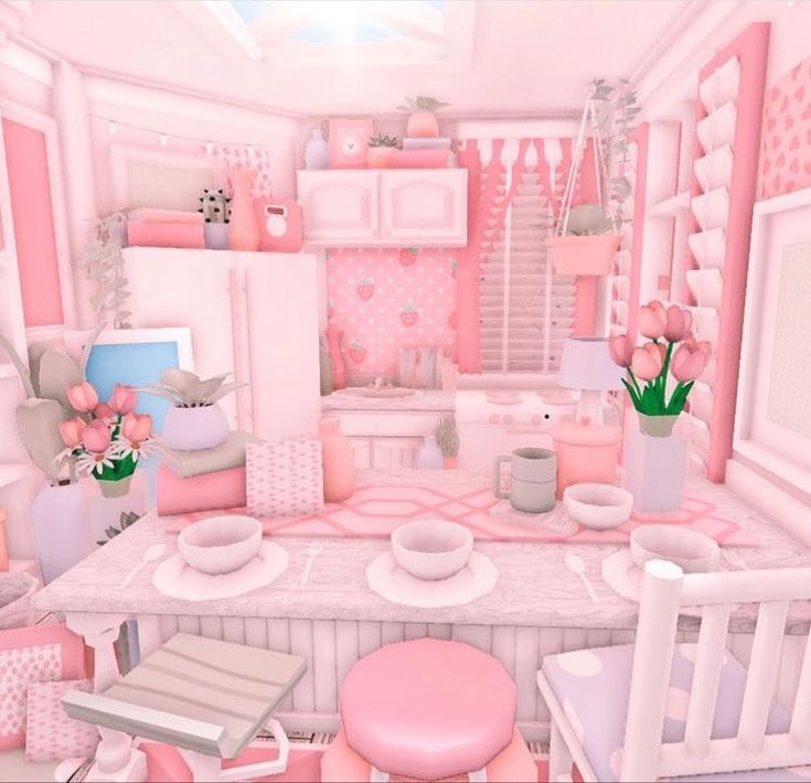 a pink room with white furniture and flowers in vases