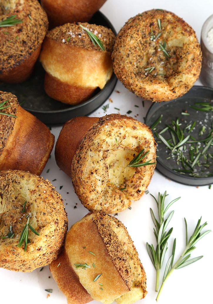 several small pastries with rosemary sprinkled on them and some dipping sauce in the background