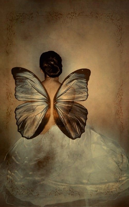 a woman in a white dress with a butterfly on her back