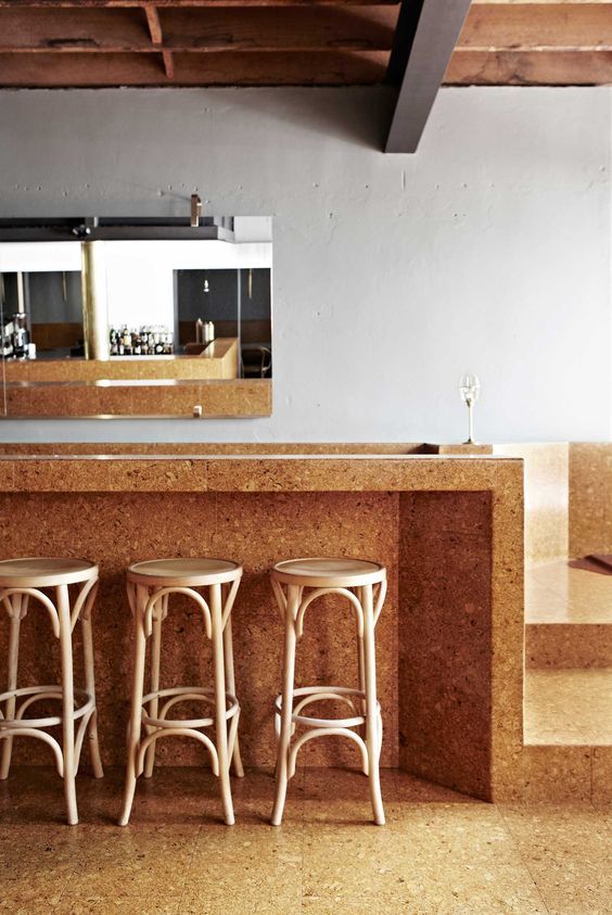 three stools sit in front of a counter