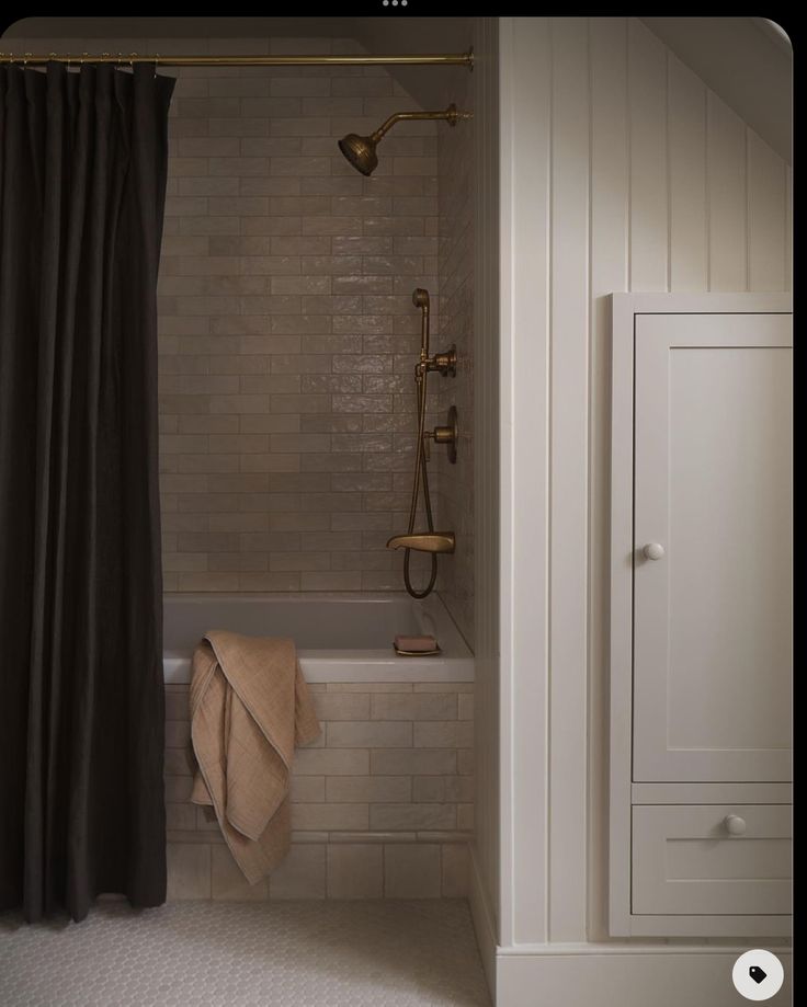 a bathroom with a bathtub, shower curtain and towel on the rack next to it