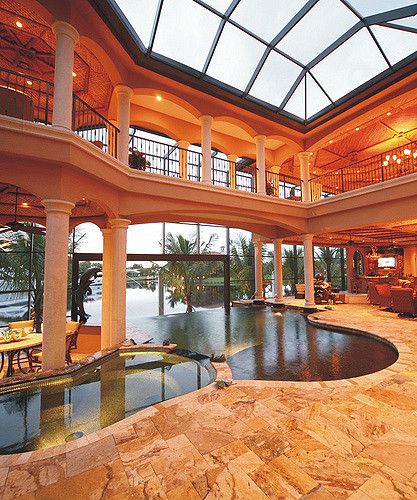 an indoor swimming pool in the middle of a house