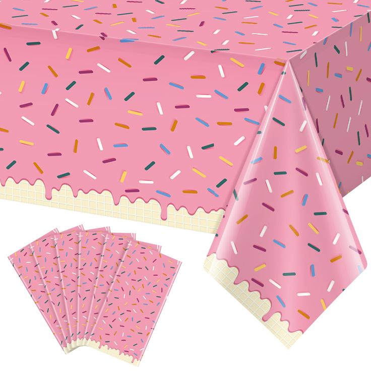 a pink table cloth with sprinkles on it and matching placemats