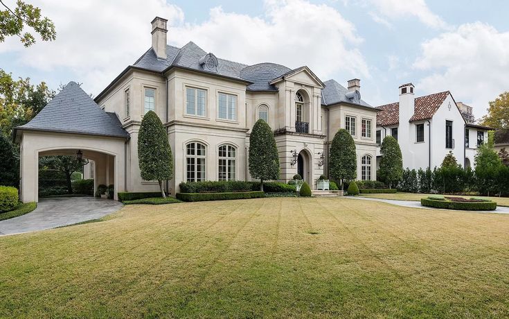 a large house with many windows and bushes