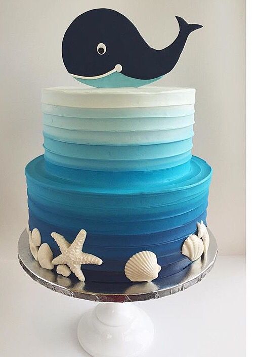 a blue and white cake with a whale on top