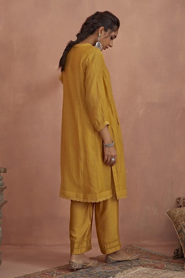 Yellow chanderi kurta with floral hand embroidered yoke and side pockets. Comes with cotton silk pant and a cotton slip.
Components: 3
Pattern: Hand embroidered
Type Of Work: Floral
Neckline: Round
Sleeve Type: Puffed Sleeves
Fabric: Kurta: Chanderi, Pant: Cotton silk, Slip: Cotton
Color: Yellow
Other Details: 
Length:
Kurta: 42 inches
Pant: 38 inches
Closure: Kurta - Front buttons
Occasion: Mehendi and Haldi - Aza Fashions Yellow Kurta, Silk Pant, Cotton Slip, Silk Pants, Silk Slip, Puffed Sleeves, Pant Set, Set For Women, Cotton Silk