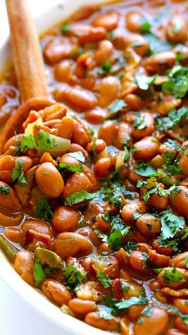 a white bowl filled with beans and cilantro