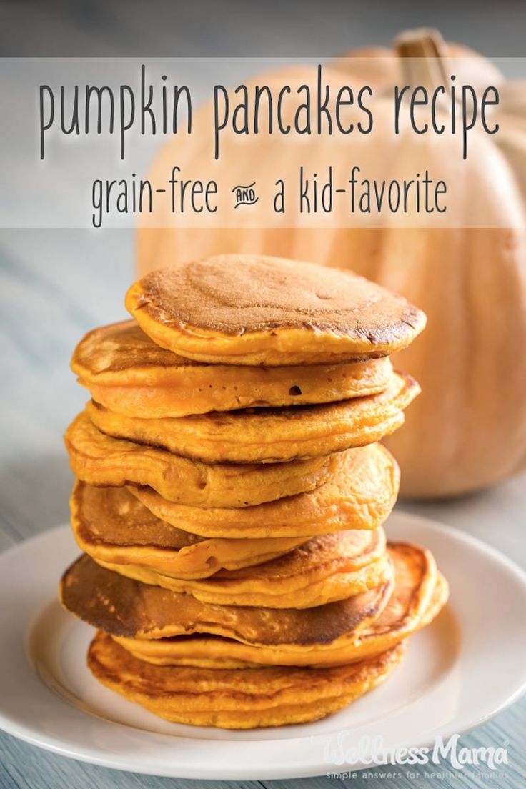 a stack of pumpkin pancakes on a white plate with a pumpkin in the background and text overlay that reads, pumpkin pancakes recipe grain - free as a kid - favorite