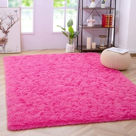 a bright pink rug in a living room