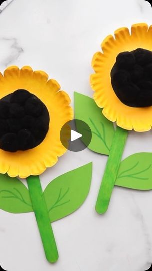 two paper flowers made to look like sunflowers