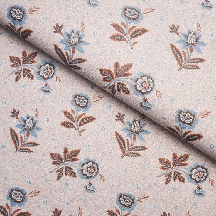 a close up view of a flowered fabric with blue and brown flowers on it