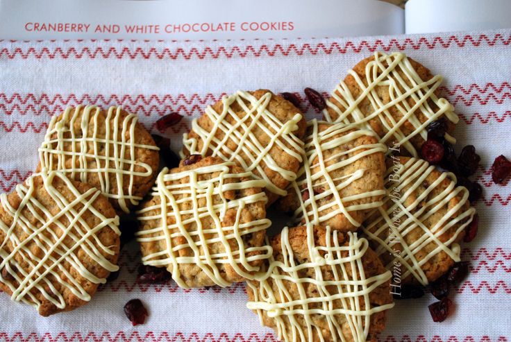 cranberry and white chocolate cookies with icing on a red and white napkin