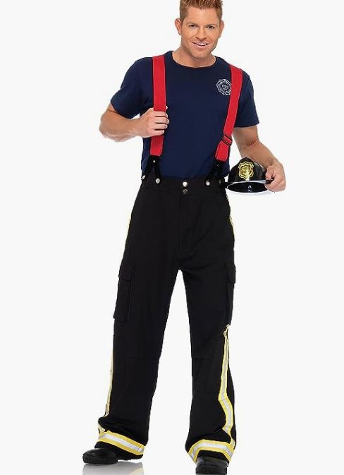 a man wearing overalls and holding a firefighter's helmet in his hands