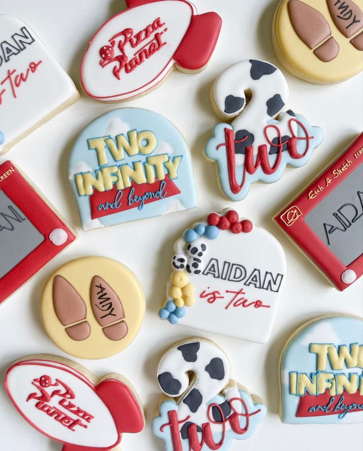 decorated cookies are arranged on a white surface