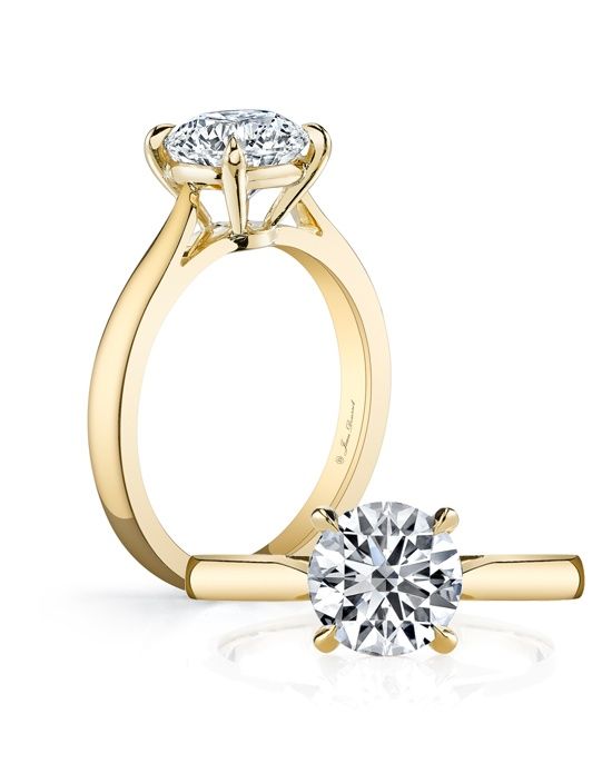 a yellow gold engagement ring with two diamonds