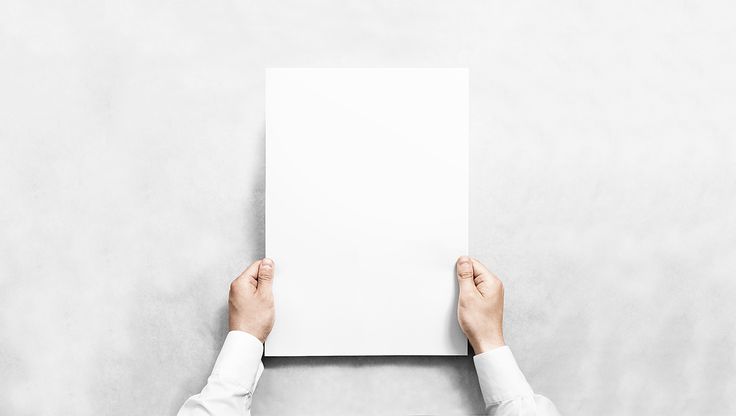 a person holding up a white piece of paper