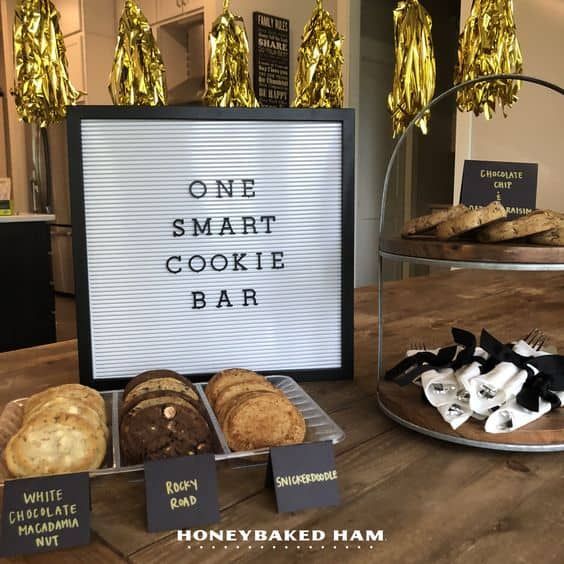 there is a sign that says one smart cookie bar next to some cookies and pastries