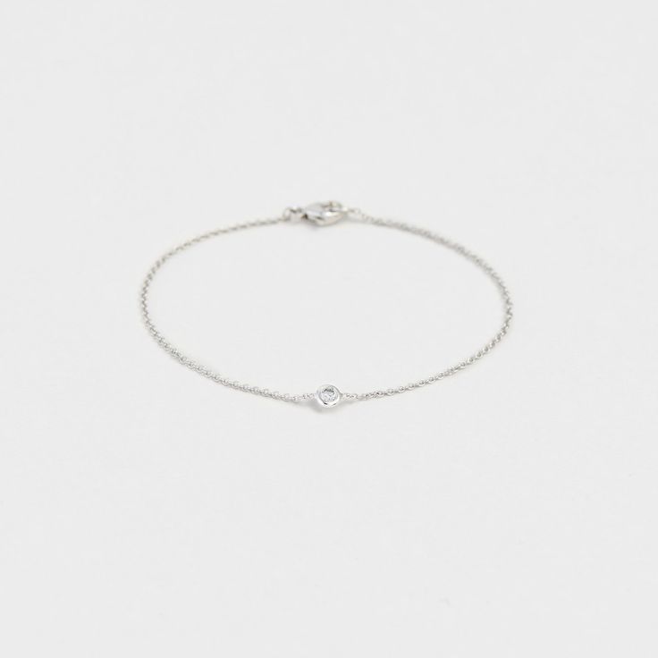 Part of our petite bezel collection, this bracelet is the perfect every day look to give as a gift to others or yourself! G-H color, SI clarity, 0.10ctw 6" length Dainty White Gold Chain Bracelet, Everyday White Gold Jewelry With Single Cut Diamonds, Elegant Stackable White Gold Chain Bracelet, Minimalist Adjustable Jewelry With Smooth Bezel, Classic White Gold Stackable Chain Bracelet, Everyday Classic Sterling Silver Diamond Bracelet, Dainty Bezel Set Chain Bracelet, Delicate Round Bracelets With Single Cut Diamonds, Dainty 14k Gold Tennis Bracelet For Everyday Wear