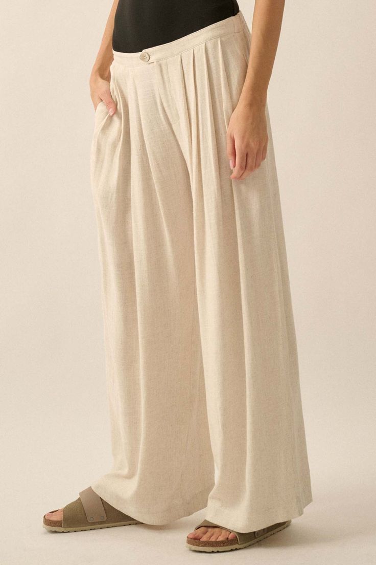 Solid linen-blend pants. Pleated front. Side-seam pockets. Waist button closure and zip-up fly. Wide leg. Elastic-back waist. Ankle length. Loose fit. 70% Rayon, 30% Linen. Imported. Designed in LA. Model wears size S. Beige Linen Bottoms With Elastic Waistband, Beige Linen Pants With Elastic Waistband, Chic Trousers In Flax Color, Neutral Linen Straight Pants, Neutral Linen Pants With Elastic Waistband, Neutral Wide-leg Pants With Pockets, Casual Wide Leg Flax Bottoms, Linen Bottoms With Elastic Waistband In Flax Color, Chic Flax Colored Linen Bottoms