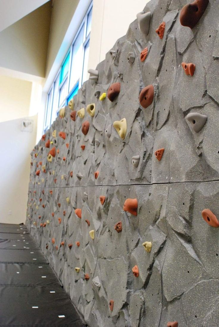 an indoor climbing wall is shown in this image, it looks like there are many rocks on the wall