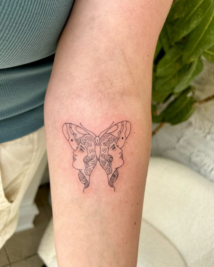 a woman's arm with a butterfly tattoo on the left side of her body