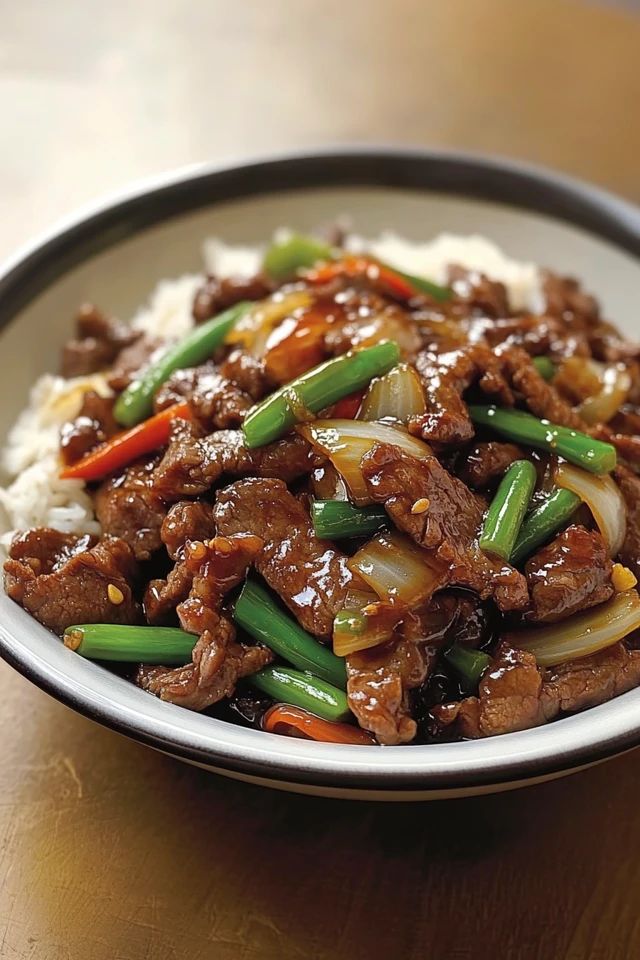 a white plate topped with meat and vegetables on top of rice covered in sauces