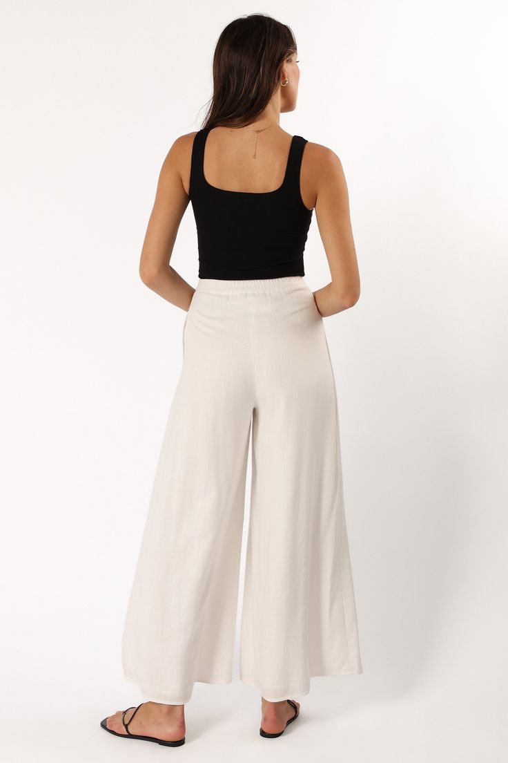 DETAILS   Are you ready to turn heads and show off your style? We've got the perfect pant for you! These wide leg pants are ideal for making a chic statement and will take your wardrobe up a notch. The high waist, front pleating detail, belt loops, and functional pockets add to their stylish appeal.  wide leg style pant  high waisted  elasticised waistband at back  front invisible zip with button close  belt loops  functional pockets  lined  material - 70% rayon / 30% linen    SIZING     model i Chic Wide-leg Workwear Bottoms, Chic Wide Leg Workwear Bottoms, Chic Wide Leg Bottoms For Workwear, Chic Wide Leg Pants With Elastic Waistband, Versatile Wide Leg Spring Dress Pants, Spring Wide Leg Versatile Dress Pants, Versatile Wide-leg Spring Dress Pants, Chic Spring Wide Leg Pants With Loose Fit, Spring Wide Leg Dress Pants