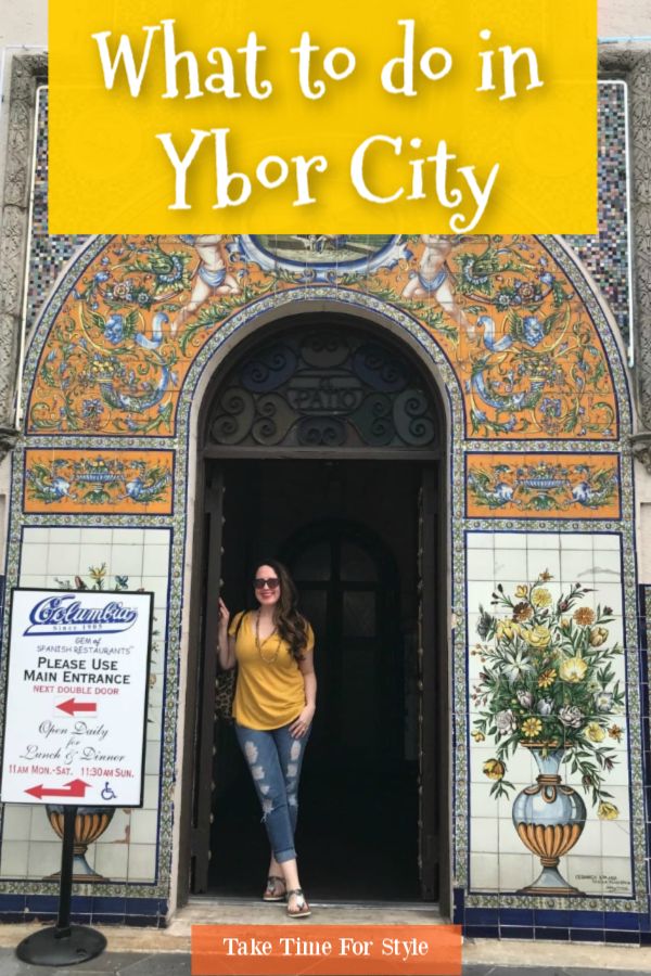 a woman standing at the entrance to a colorful building