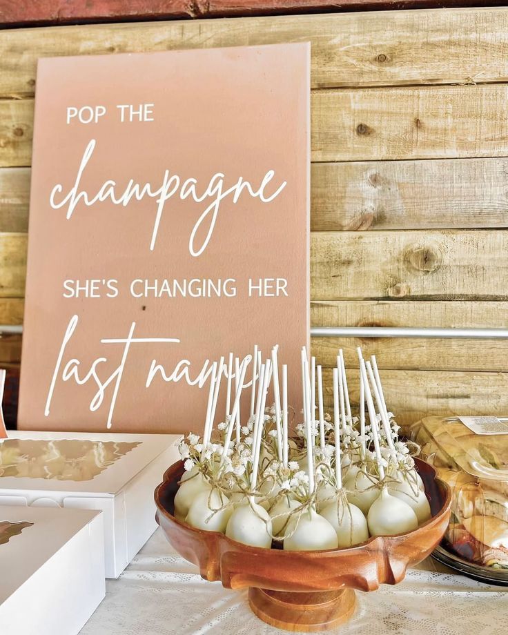 there is a sign that says pop the champagne she's changing her last name