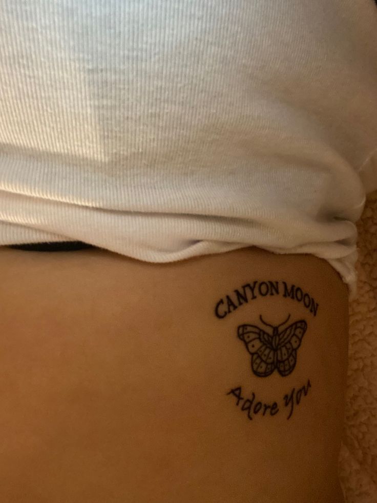 the back of a woman's stomach with a tattoo on it that says canyon moon before you