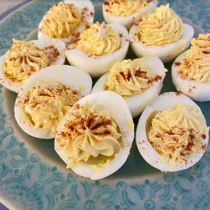 several deviled eggs are arranged on a blue plate