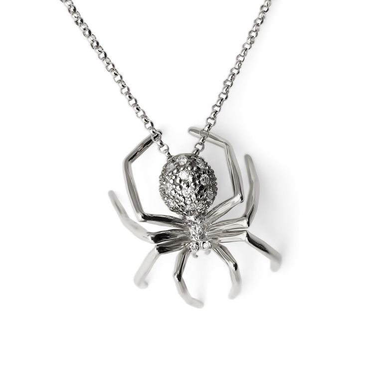 "Introducing the captivating Limited Edition Spider Pendant, a stunning embodiment of creativity and self-determination. Crafted with meticulous attention to detail, this exquisite piece features 13 brilliant-cut round diamonds, pave set in 14k white gold. The Spider pendant itself measures an impressive 28mm x 22mm, making it a striking statement piece that is sure to draw attention. Suspended from a sleek and elegant 15\" - 16\" 14k gold chain, this pendant rests perfectly on the wearer's déco White Gold Diamond Necklace For Evening, Luxury Diamond White Diamond Necklace For Gift, Luxury Diamond White Diamond Necklace As Gift, Evening White Gold Diamond Necklace, Brilliant Cut White Gold Diamond Necklace For Evening, Exquisite Silver Diamond Cut Necklace, Exquisite Silver Diamond Cut Diamond Necklace, Exquisite Silver Diamond Necklace With Diamond Cut, Evening Single Cut Diamond Necklace