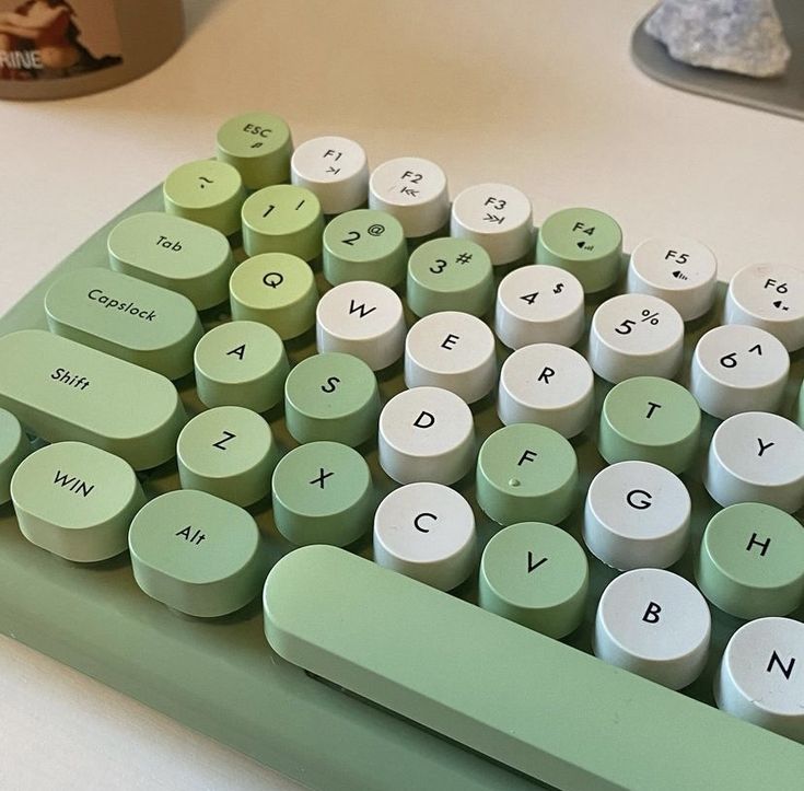 a green and white keyboard sitting on top of a table